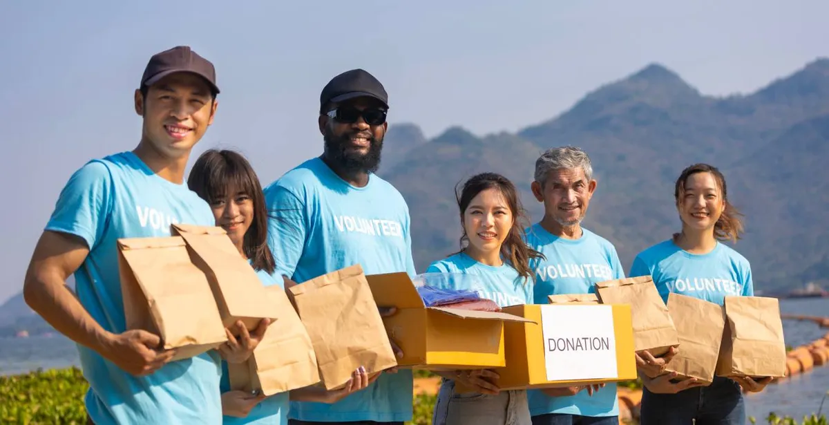 Volunteers holding donated supplies